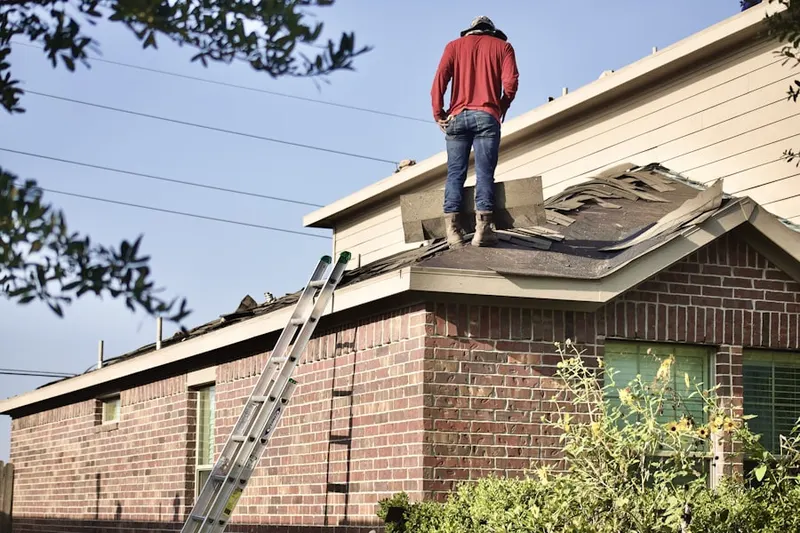 Professional roofer working on a residential roof in Park Layne Manor